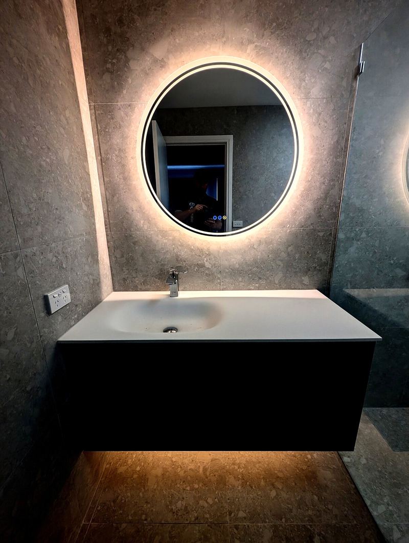 Backlit bathroom mirror and vanity strip light
