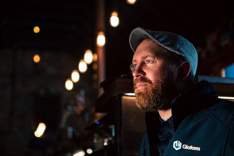 Blake in a Gloform jacket with pendant lights behind him