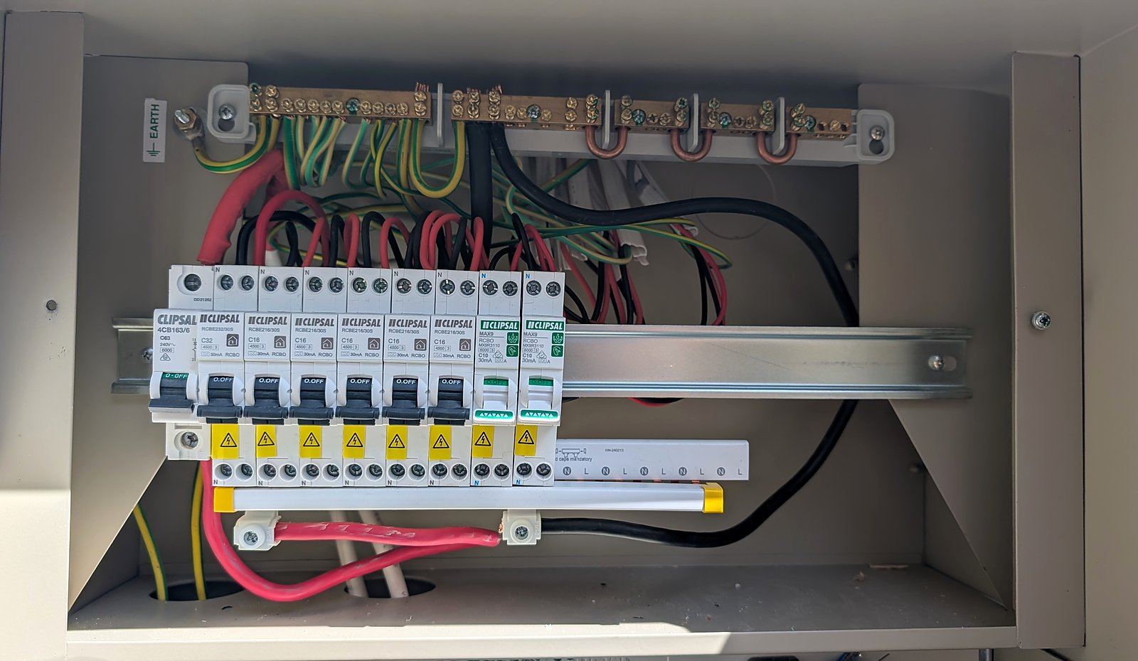 New Clipsal breakers installed on a switchboard rail