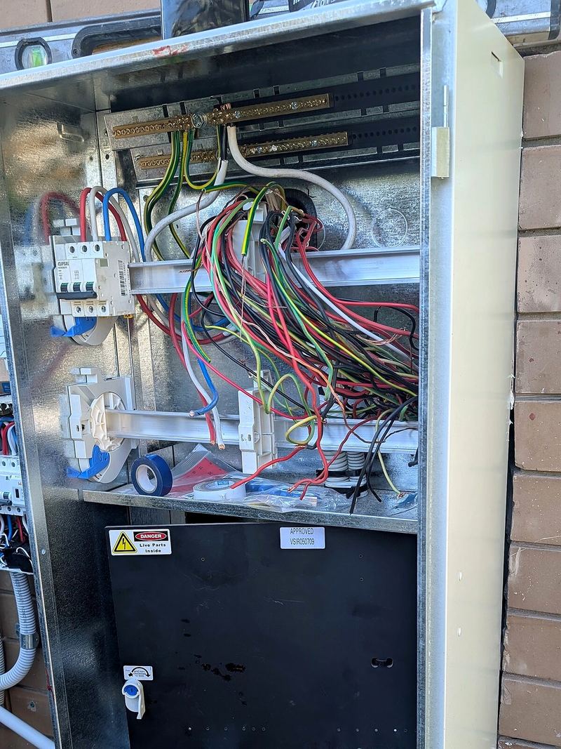 New switchboard enclosure open, with cables dressed in during the upgrade