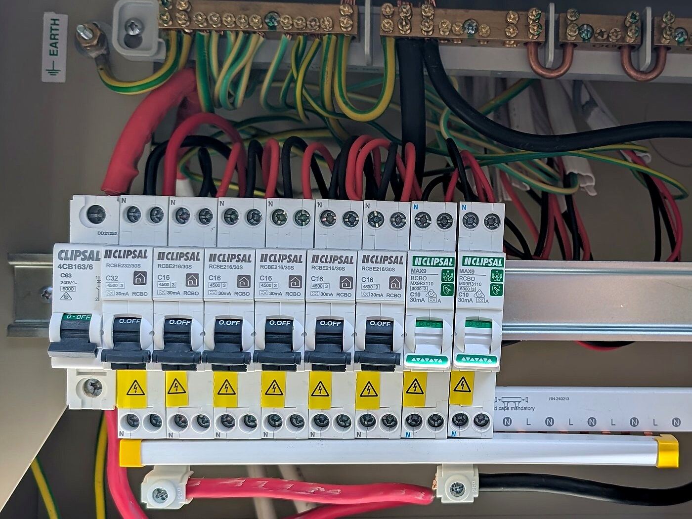 Open switchboard with circuit breakers and the earth bar