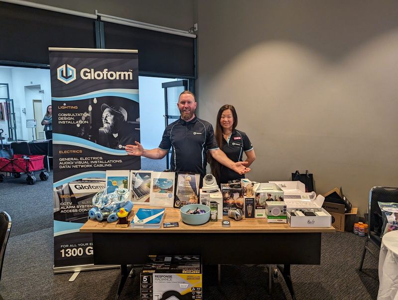 Gloform stand at an expo, with lighting and camera gear on the table