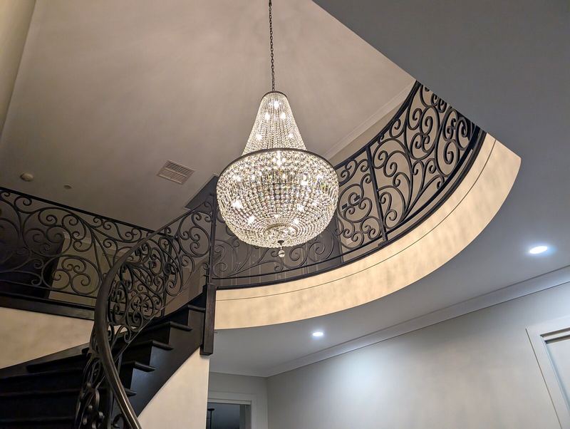 Chandelier hung in a curved stairwell