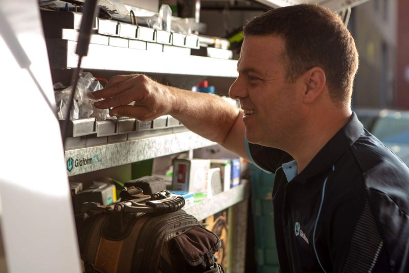 Parts shelves in the van, with a Gloform electrician reaching for a fitting